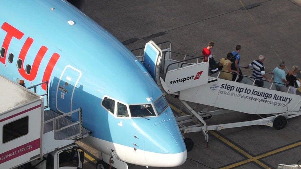 Passengers disembark a Tui plane