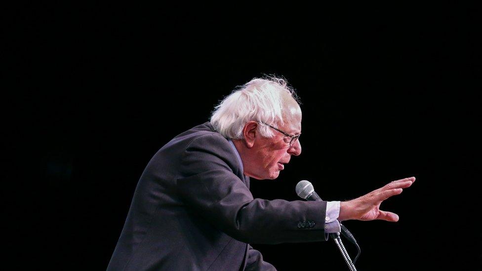 Bernie Sanders speaks into a microphone