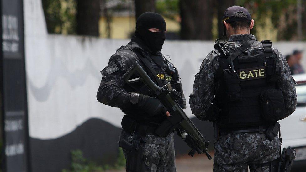 Policemen are seen at the Raul Brasil school after a shooting in Suzano