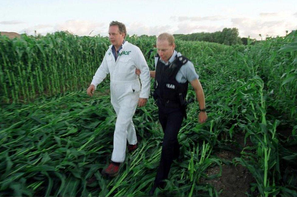 Greenpeace executive director Lord Peter Melchett being led away by a policeman during a protest by enviromental campaigners against genetically modified crops at Lyng, near Norwich, Norfolk