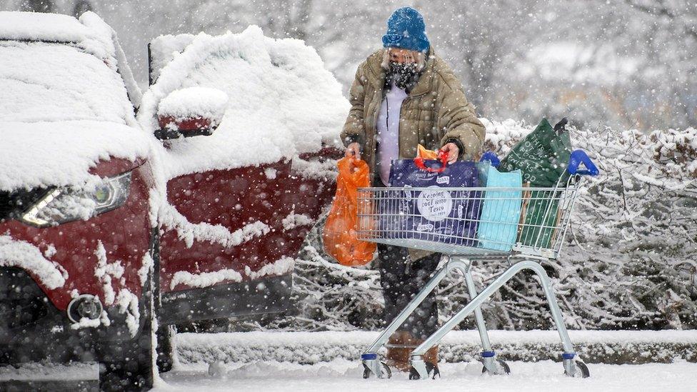 Woman loads shopping into a car in Dunstable, Bedfordshire