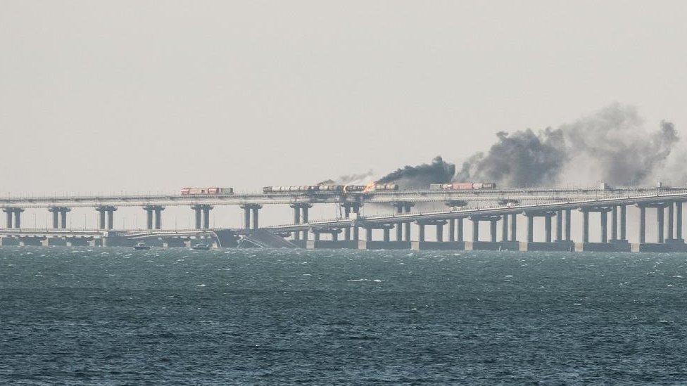 Fuel tanks ablaze and damaged sections of the Kerch bridge in Crimea