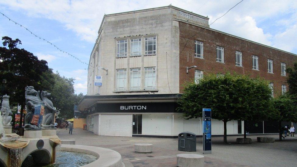 a building with a sign saying 'Burton'