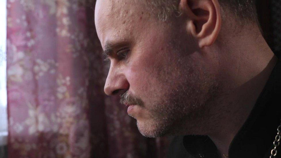 Father Ioann Burdin in a close-up profile in a home