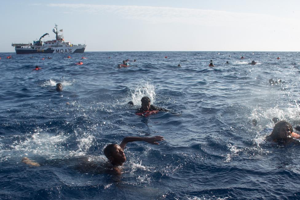 Migrants swimming in the Medterranean after their boat capsized near Lampedusa in May 2017