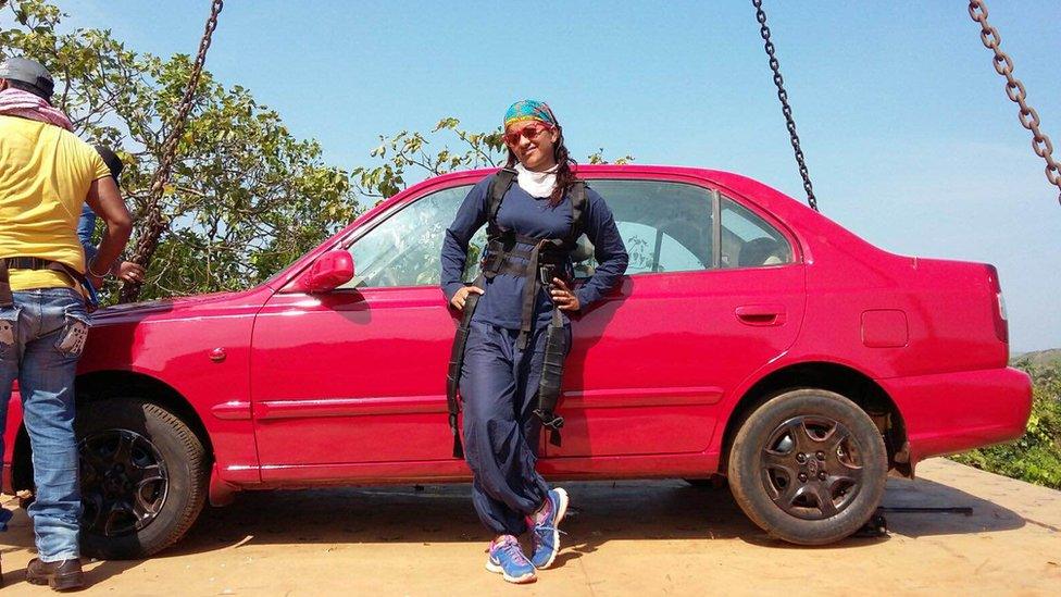 Geeta Tandon leaning on a car