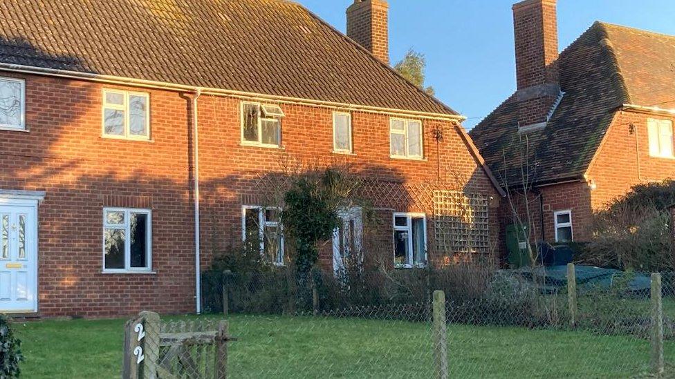 Two-storey brick house with small front garden