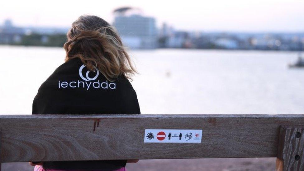 A woman looks out across Cardiff Bay