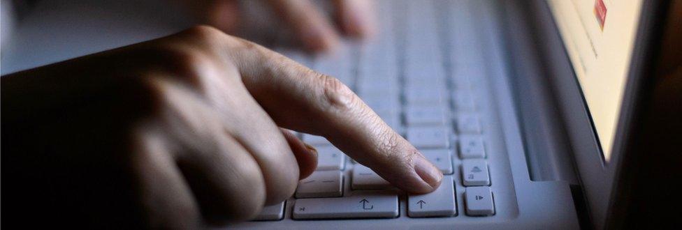 Hands on a laptop keyboard