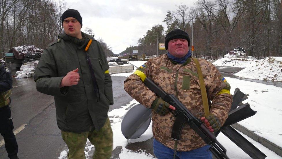 Johnny Dragan and one of his soldiers at a Ukrainian checkpoint north-west of Kyiv