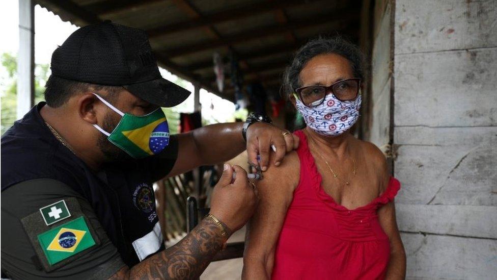 A health worker of the Indigenous Special Sanitary District of Manaus administers Sinovac"s CoronaVac coronavirus disease (COVID-19) vaccine to an Indigenous person at Sao Jose Village in the Indigenous land Rio Urubu from the ethnicity Mura in the Urubu river banks in Itacoatiara, Amazonas state, Brazil, February 13, 2021.