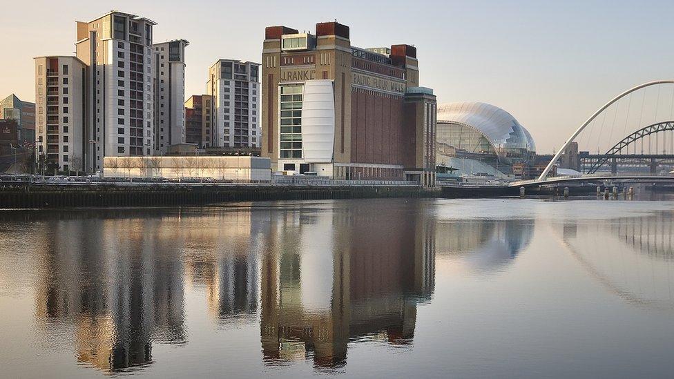 Buildings on Gateshead riverside reflected in the river