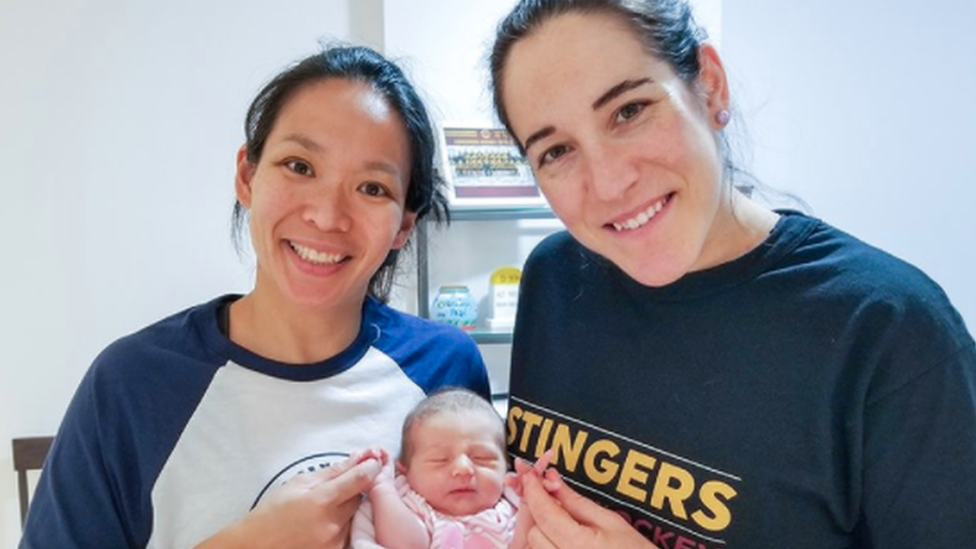 Julie Chu (left) and Caroline Ouellette with baby Liv