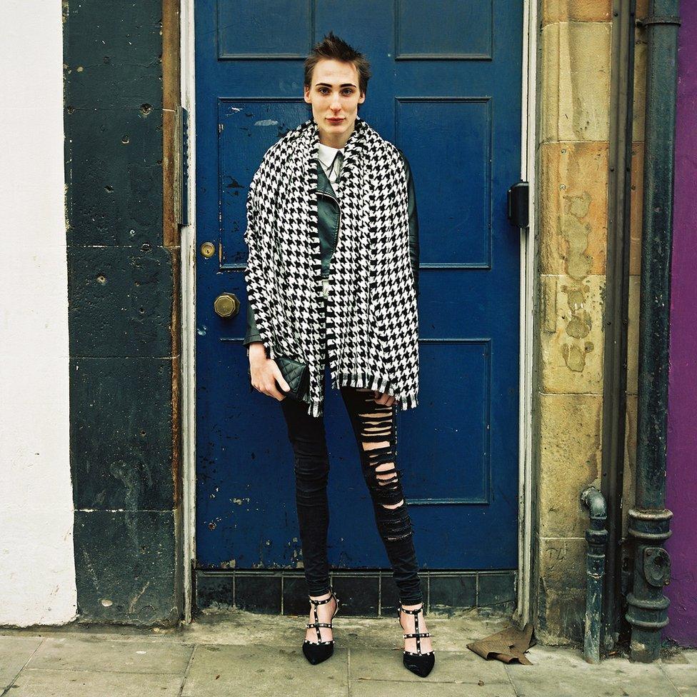 Woman in front of a blue door