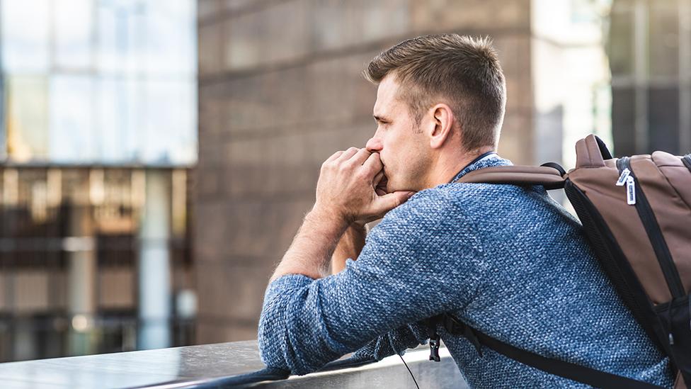 Man looking thoughtful over bridge