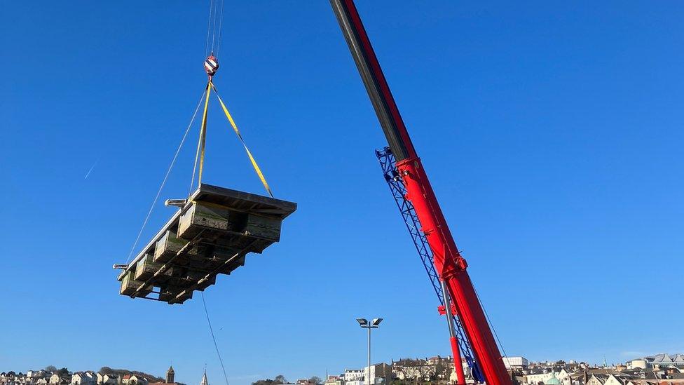 Pontoons being craned into St Peter Port Harbour