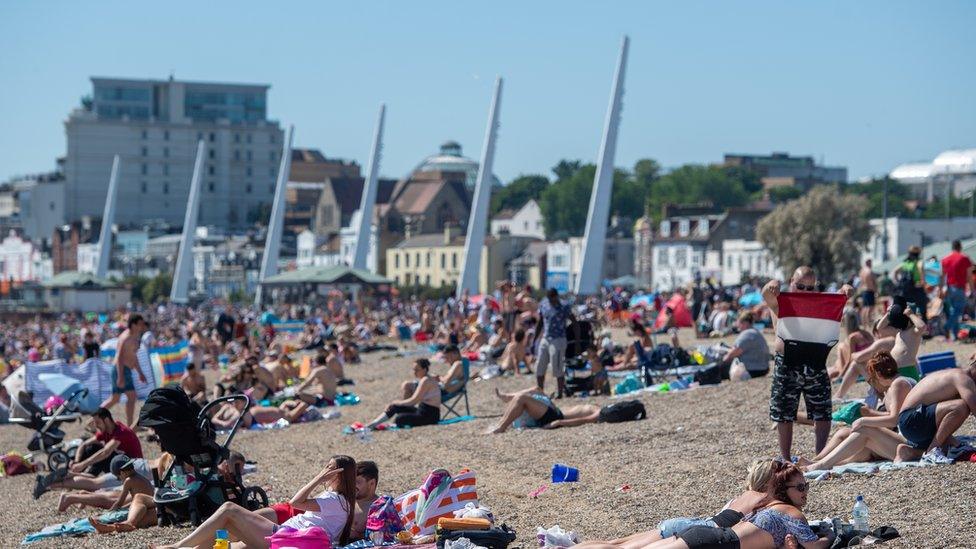 People enjoying the good weather on the beach at Southend-on-Sea in Essex