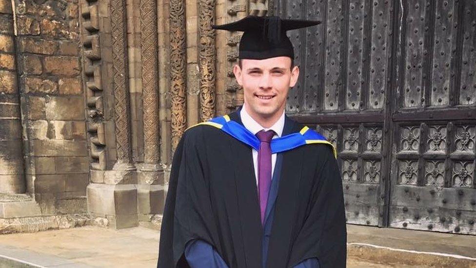 Rhys Dickinson in mortar board and gown