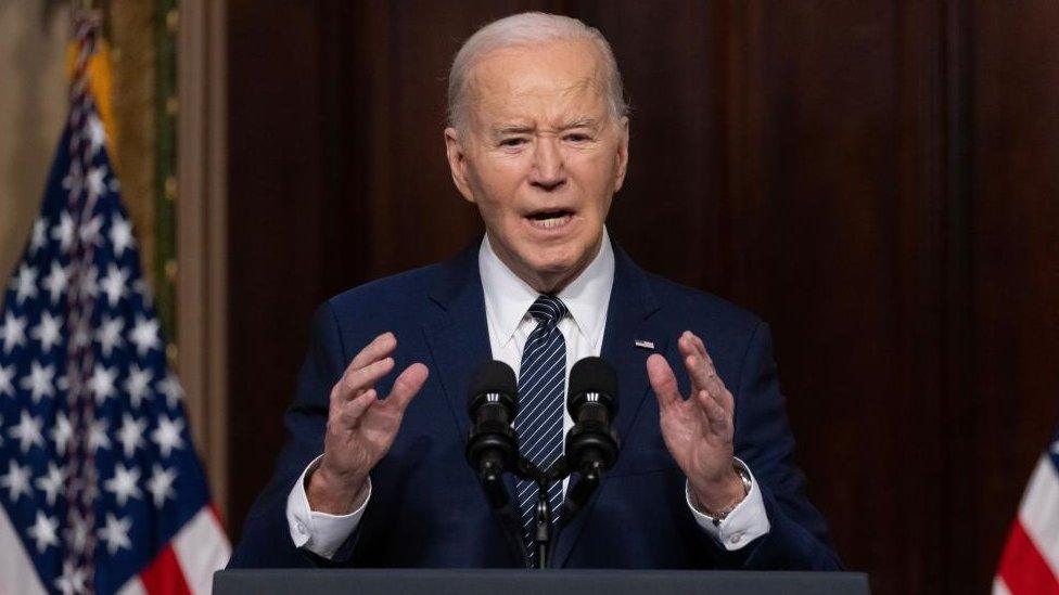 US President Joe Biden delivers remarks at a microphone