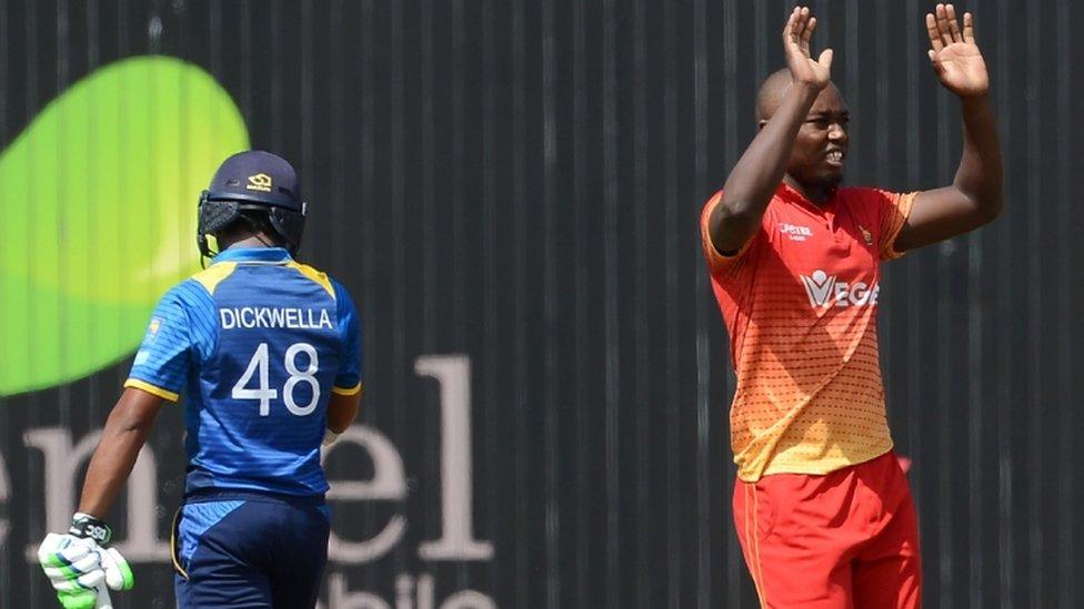 Tendai Chatara (R) celebrates after he dismissed Sri Lankan cricketer Niroshan Dickwella