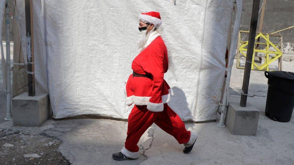 A volunteer characterized as Santa Claus to deliver food, toys and blankets to street populations and people at risk in Mexico City