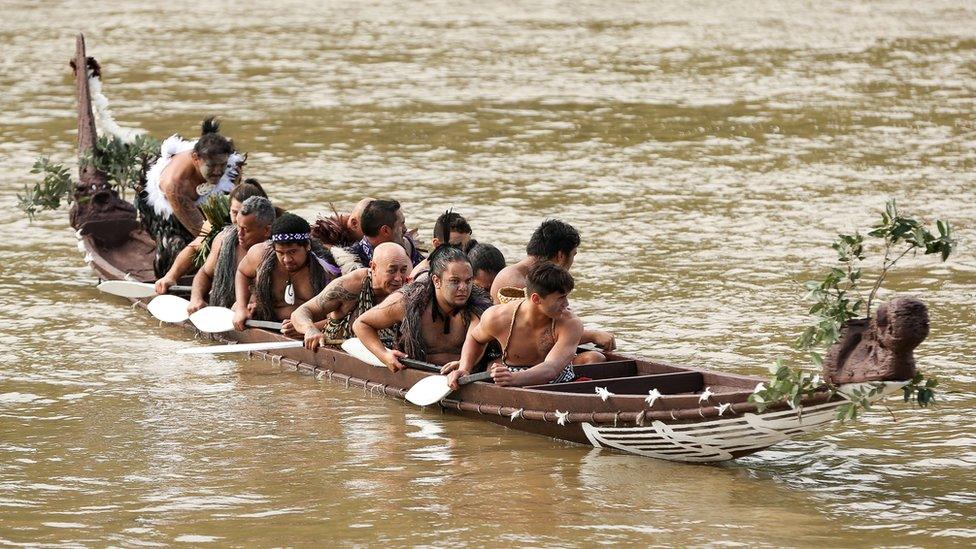 Members of the crew rest their paddles after paddling with Prince Harry on the Whanganui River during a visit to Putiki Marae on 14 May 2015 in Wanganui, New Zealand.