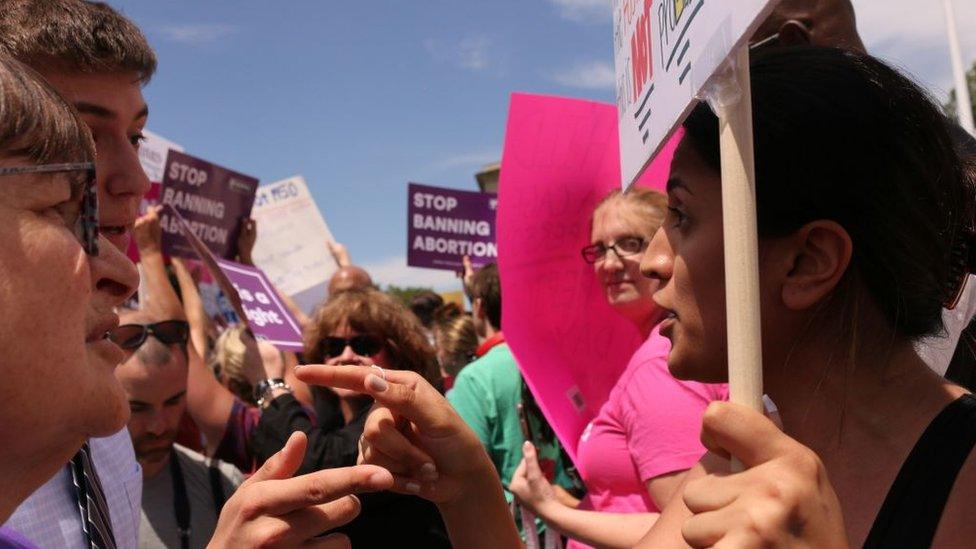 A pro-choice supporter argues with a pro-life supporter in front of the US Supreme Court in Washington DC on May 21, 2019