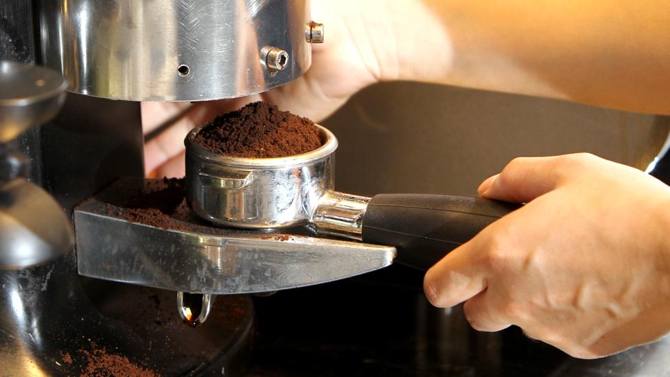 A barista making coffee