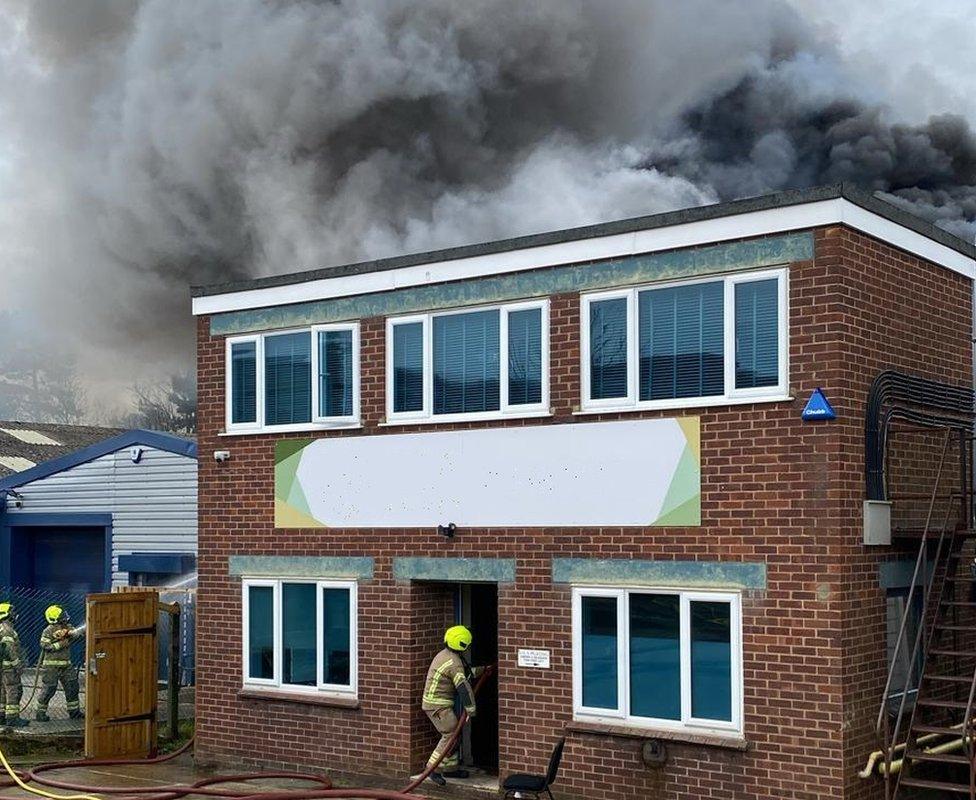 A business unit with black smoke appearing behind it