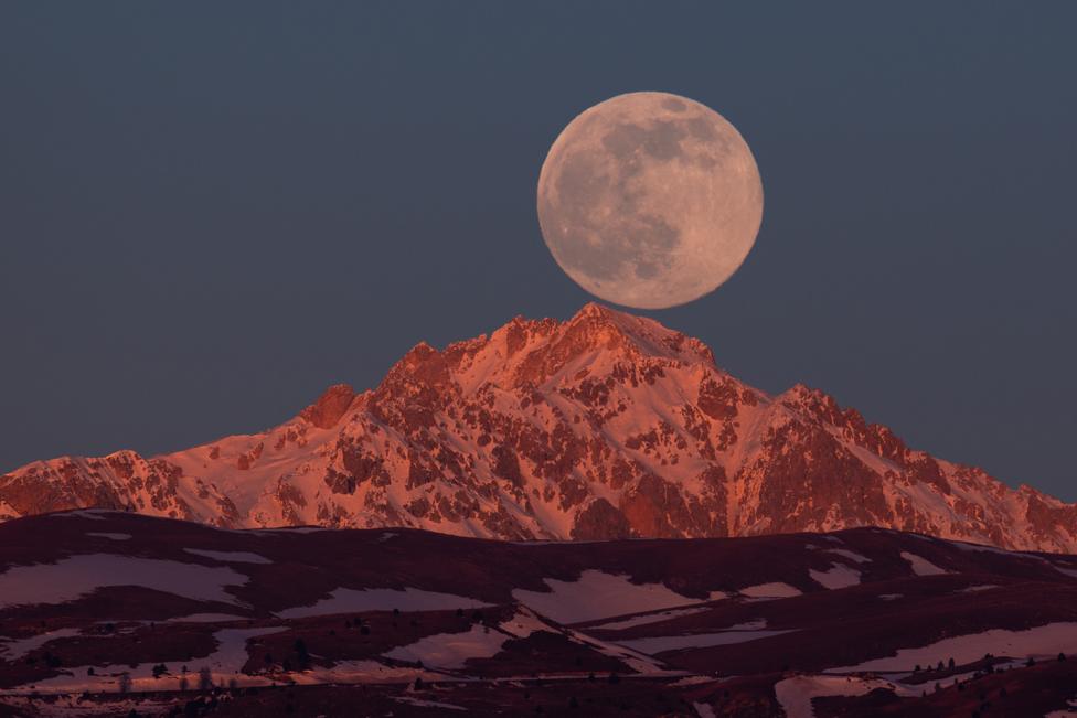 Full moon sets behind Monte Prena in Gran Sasso d'Italia National Park on January 2022