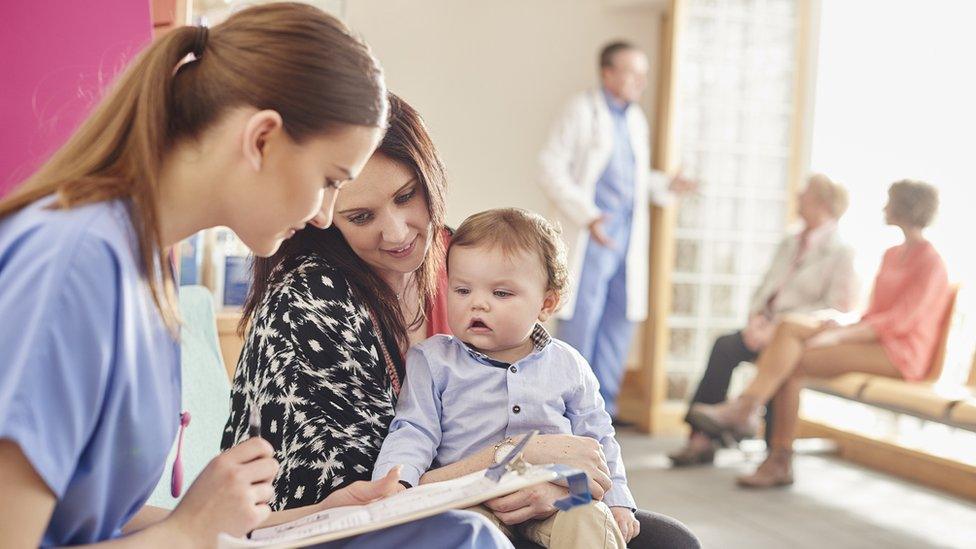 Nurse treating mother and child