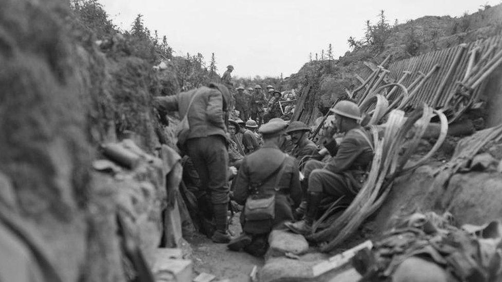 Soldiers sheltering in a trench