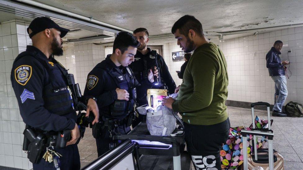 Police check bags at a New York City subway station.