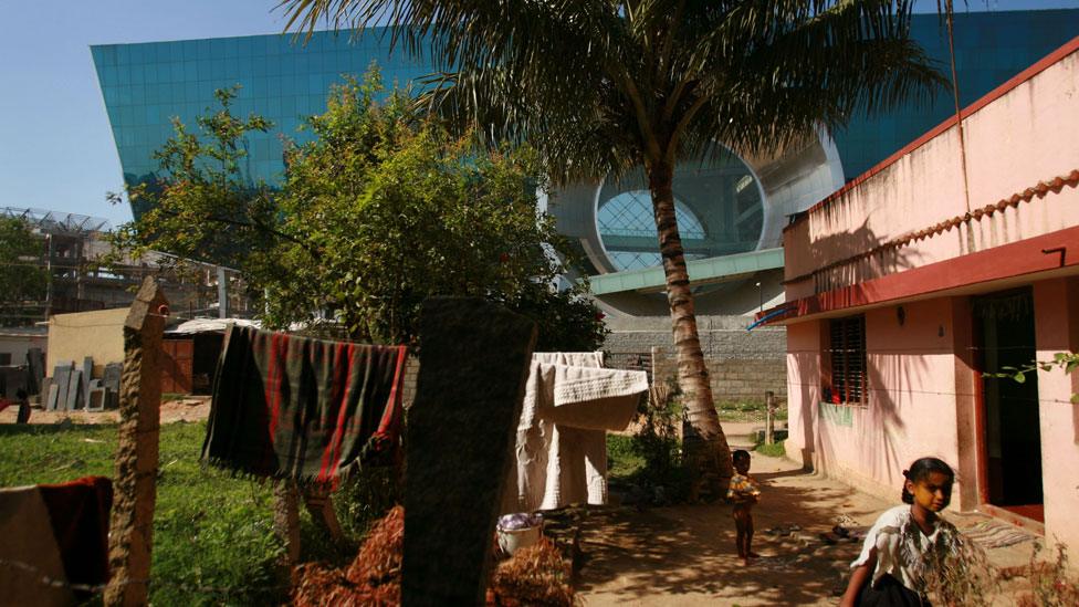 Technology building looms over houses in Bangalore