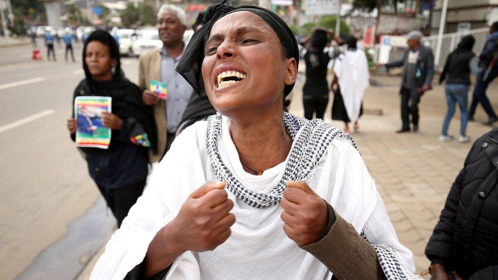 A woman reacts during the funeral ceremony of Simegnew Bekele