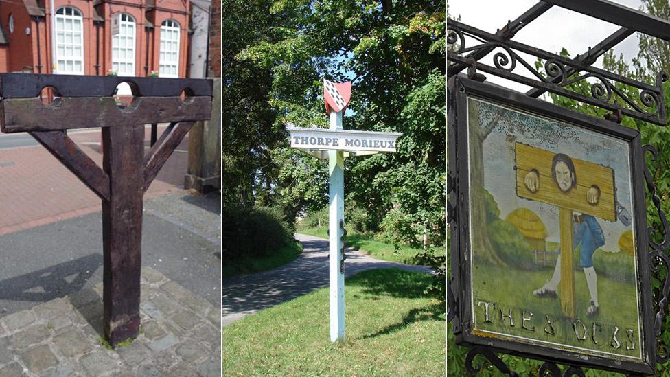 pillories and a sign