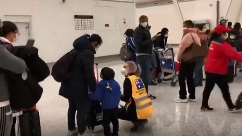 Line of Australians waiting at Wuhan Airport to board the evacuation flight to Christmas Island