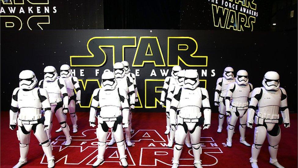 Stormtroopers in front of Star Wars sign