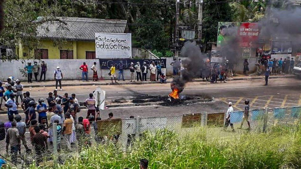 Protesters block a road and set alight tyres in Rambukkana on April 19, 2022