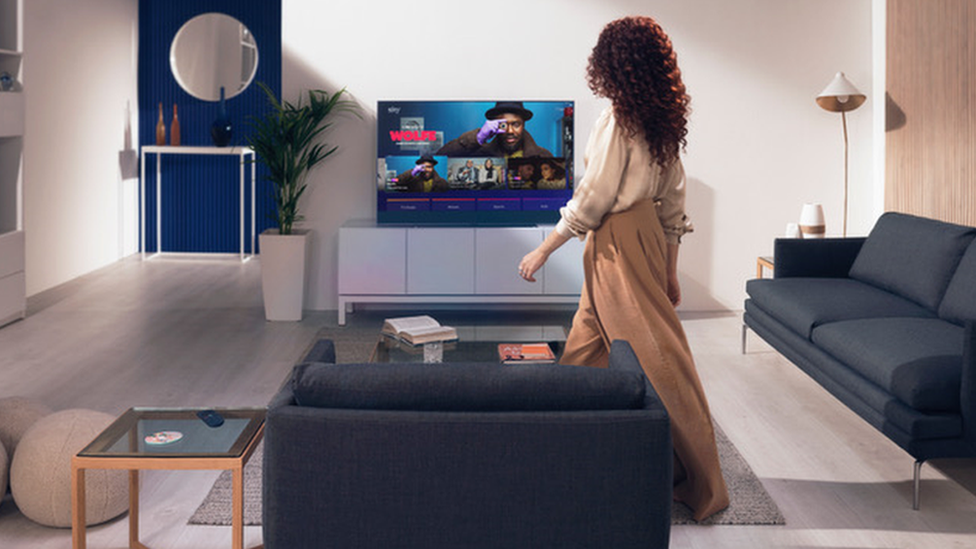 Woman in living room with Sky Glass