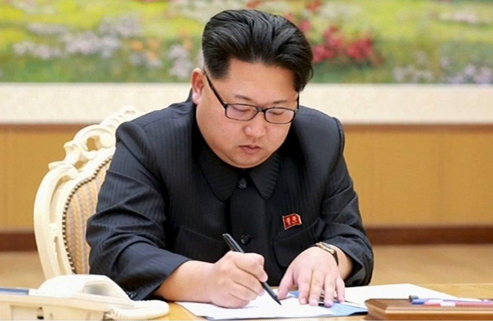 North Korean leader Kim Jong-Un signs a document regarding the test of a nuclear bomb