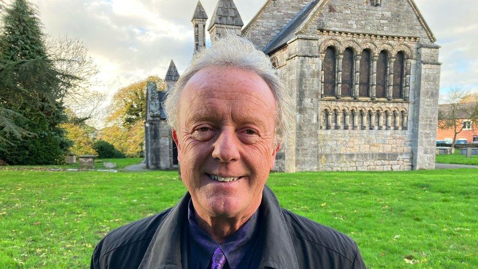 Steve Harrison standing in front of St Agatha church