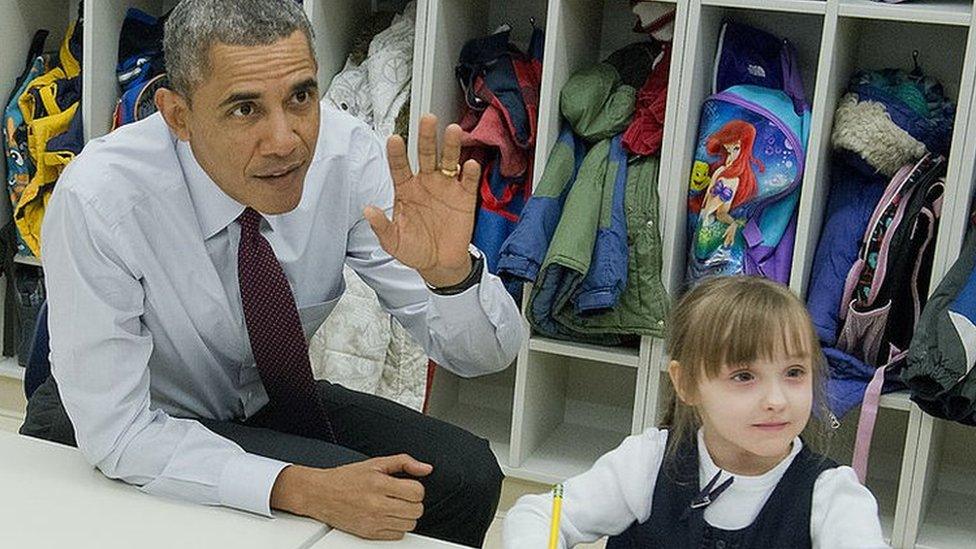 Obama raising his hand in the classroom