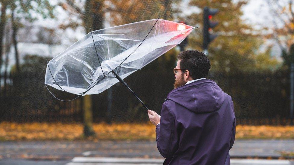 Man holds an upside down umbrella