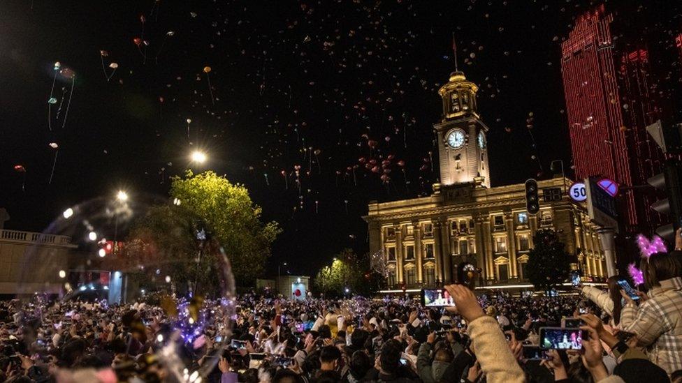 Crowds celebrate outside Customs House Clock Tower in Wuhan