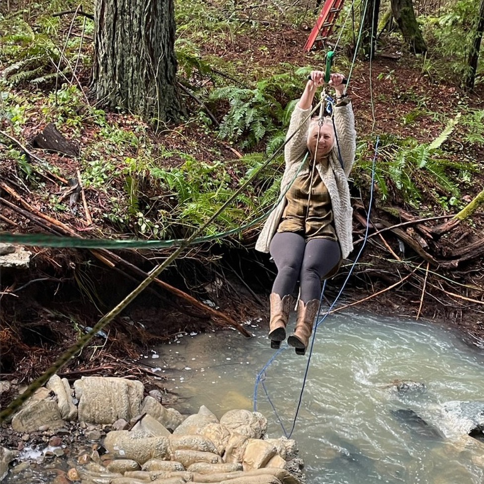 Stacey Cooper ziplines across the creek