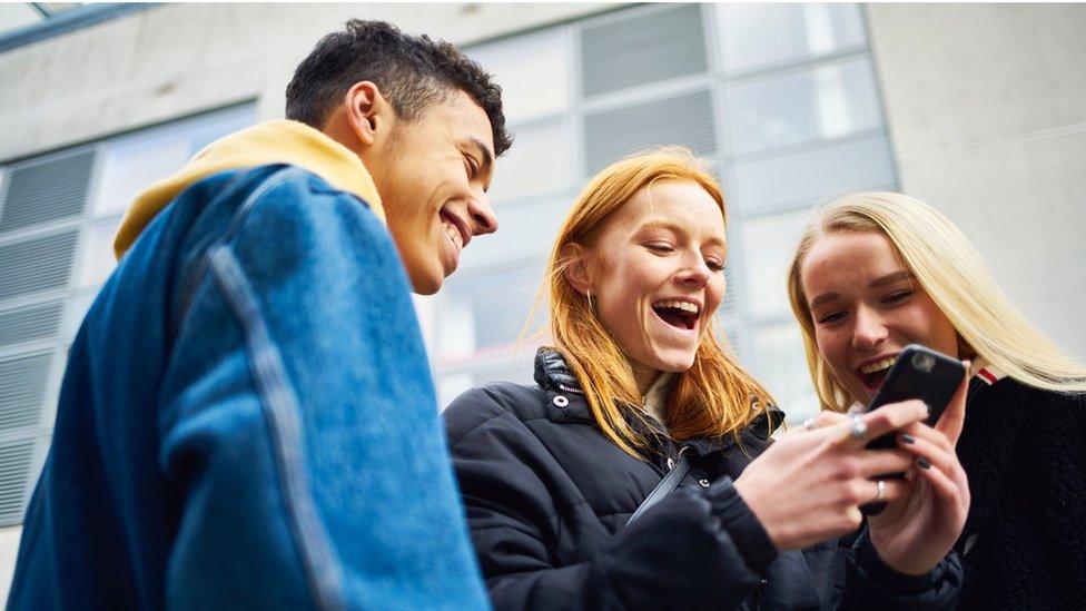 Group of people looking at a mobile