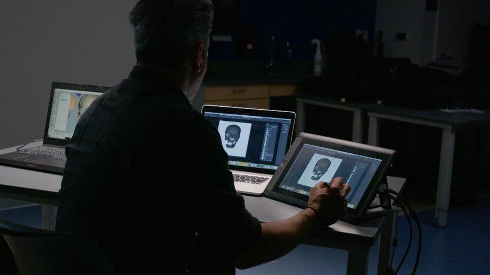 Man working on computer reconstruction of face Roman crucifixion victim