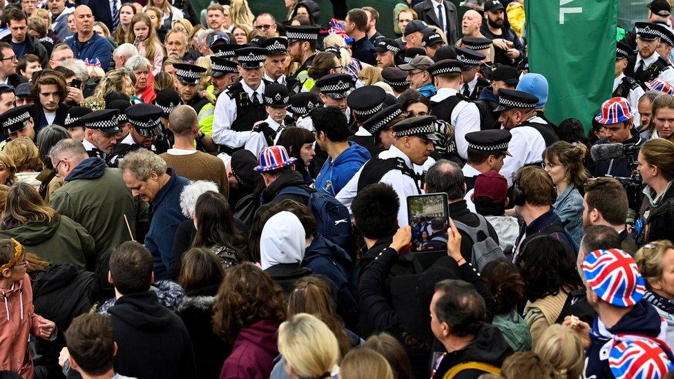 Protesters from climate protest group 'Just Stop Oil' are apprehended by police officers in the crowd