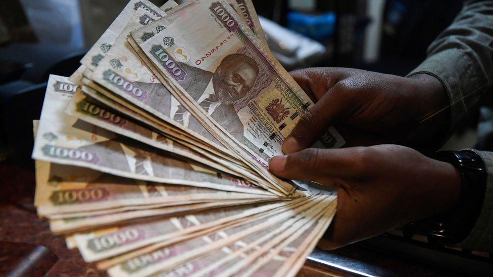 A currency dealer counts Kenyan shillings at a money exchange bureau on September 19, 2018 in the Kenyan capital Nairobi.